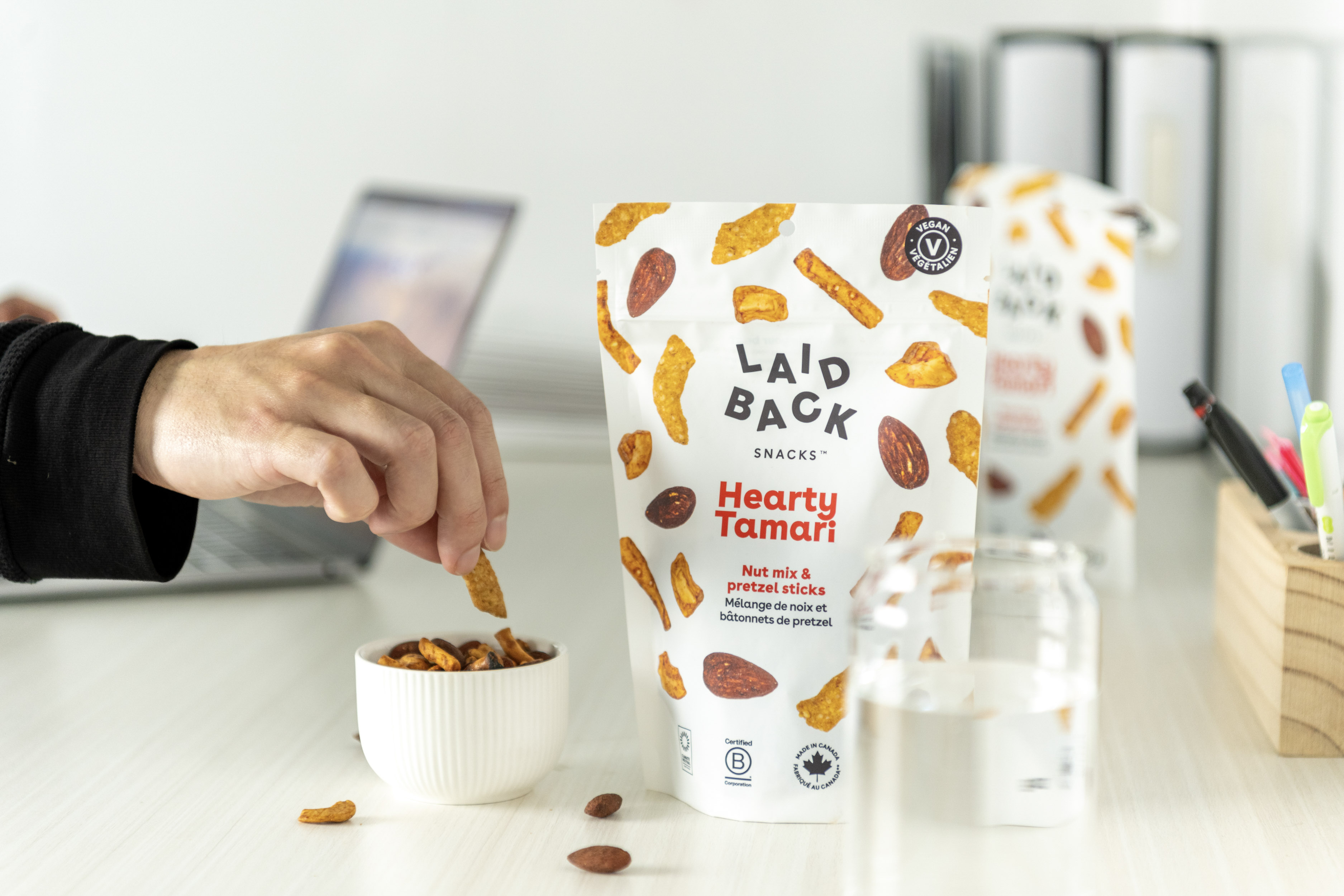 Hearty Tamari on an office desk with a snack bowl and laptop